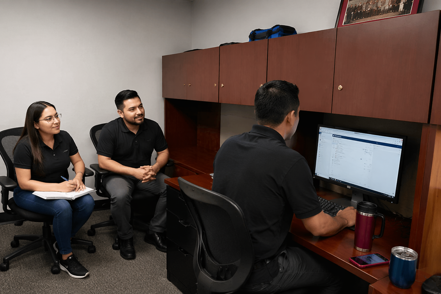 Family Security team reviewing commercial security system data with colleagues at Ottawa office workspace