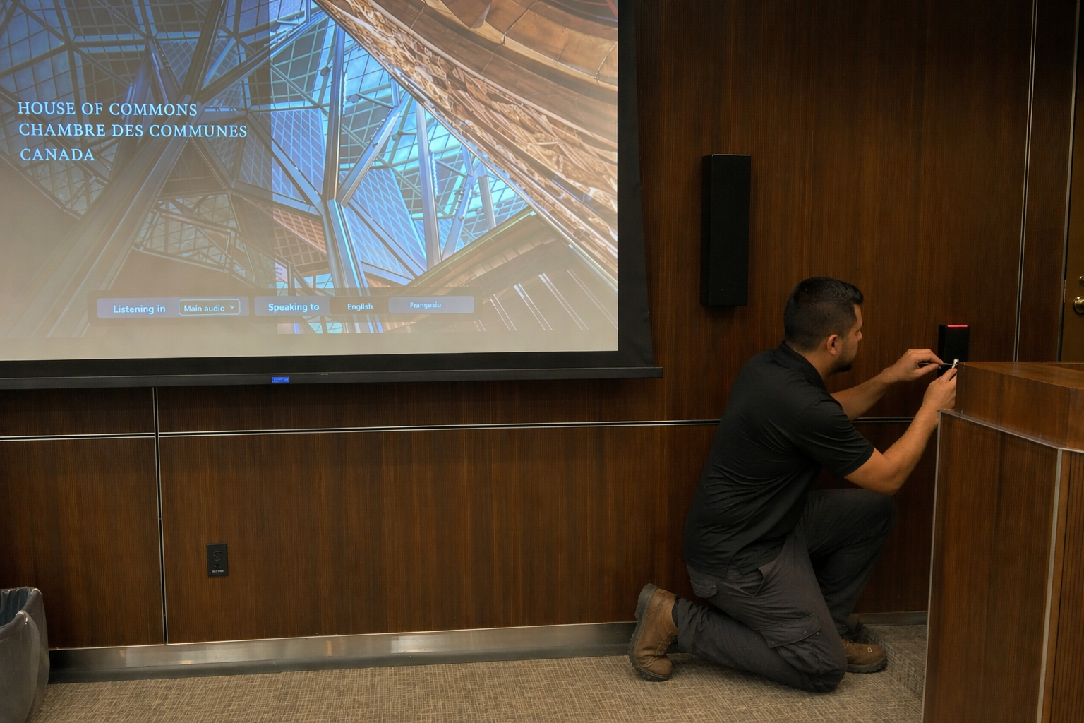 Access control Ottawa — technician installing wall-mounted card reader in commercial conference room
